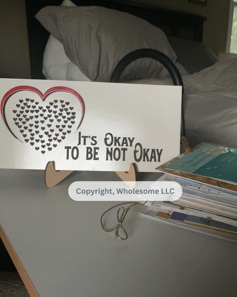 "It's okay to be not okay" signage and a stack of 'Get Well' cards sent to me after my breast cancer diagnosis.